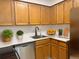 Modern kitchen with stainless steel dishwasher, updated countertops and wood finish cabinets at 390 Zang St # 5-102, Lakewood, CO 80228