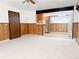 Open living room with a breakfast bar, new stainless steel appliances, and wood-look paneling at 390 Zang St # 5-102, Lakewood, CO 80228