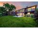 A spacious backyard featuring a well-maintained lawn, patio with fire pit, and a second-story deck at 8696 W Iliff Ave, Lakewood, CO 80227