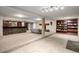 Spacious basement with stone bar area, recessed lighting and built-in shelving at 8696 W Iliff Ave, Lakewood, CO 80227