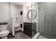 Modern bathroom featuring glass shower, contemporary vanity, and stylish tile at 8696 W Iliff Ave, Lakewood, CO 80227