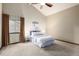 Spacious bedroom featuring a vaulted ceiling, neutral color palette, and plush carpeting at 8696 W Iliff Ave, Lakewood, CO 80227