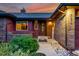A warm and inviting front entrance featuring decorative details and lush landscaping for curb appeal at 8696 W Iliff Ave, Lakewood, CO 80227