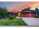 Charming single-Gathering home featuring a well-maintained lawn, a brick facade, and a spacious two-car garage at 8696 W Iliff Ave, Lakewood, CO 80227