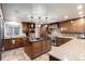 A modern kitchen featuring custom wood cabinetry, granite counter tops, and stainless steel appliances at 8696 W Iliff Ave, Lakewood, CO 80227
