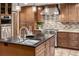 Modern kitchen features stainless steel appliances, granite countertops, and custom cabinets at 8696 W Iliff Ave, Lakewood, CO 80227
