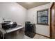 Laundry room with modern washer and dryer set with a window bringing in natural light at 8696 W Iliff Ave, Lakewood, CO 80227