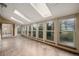 Bright sunroom with multiple windows and skylights offering natural light and serene views at 8696 W Iliff Ave, Lakewood, CO 80227
