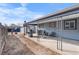 Backyard includes a covered patio with furniture, a grill, and an unfenced yard perfect for outdoor living at 2381 Newark St, Aurora, CO 80010