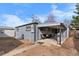 Home's backyard features a covered patio, seating, and an additional detached structure at 2381 Newark St, Aurora, CO 80010