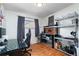 Office space includes a window and desk with black chair with a shelf and workstation area at 2381 Newark St, Aurora, CO 80010