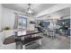 A dining room boasts an adjacent kitchen with ample natural light and cozy bench seating at 2381 Newark St, Aurora, CO 80010