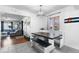 Open-concept dining room with a large dining table and an adjacent living room at 2381 Newark St, Aurora, CO 80010