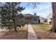 Charming single-story home featuring an orange front door, well-maintained lawn, and detached garage at 2381 Newark St, Aurora, CO 80010