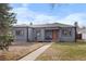 Charming gray single-story home featuring a well-maintained lawn and inviting orange front door at 2381 Newark St, Aurora, CO 80010
