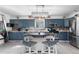 Modern kitchen with blue cabinets, stainless steel appliances, and a rustic kitchen island at 2381 Newark St, Aurora, CO 80010