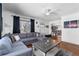 Comfortable living room features a gray sofa, hardwood floors, and a cozy atmosphere at 2381 Newark St, Aurora, CO 80010
