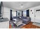 Bright living room featuring a comfortable gray sofa, hardwood floors, and natural light at 2381 Newark St, Aurora, CO 80010