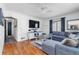 Inviting living room featuring hardwood floors, a comfortable gray sofa, and natural light at 2381 Newark St, Aurora, CO 80010