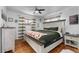 Cozy bedroom with hardwood floors, ceiling fan, and soft, natural light from large windows at 2381 Newark St, Aurora, CO 80010