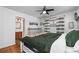 Bright bedroom with hardwood floors, neutral decor, and ensuite bathroom entrance at 2381 Newark St, Aurora, CO 80010