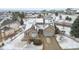 Aerial view of a stone home with solar panels on a snowy lot at 1752 Peninsula Cir, Castle Rock, CO 80104
