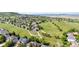 Expansive aerial view of a residential community with a golf course and mountain views at 1752 Peninsula Cir, Castle Rock, CO 80104