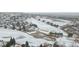 Panoramic aerial view of a home near a golf course, surrounded by a snowy landscape, offering recreation nearby at 1752 Peninsula Cir, Castle Rock, CO 80104