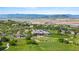 Scenic aerial view of golf course, club house, and mountain backdrop with a beautiful neighborhood at 1752 Peninsula Cir, Castle Rock, CO 80104