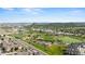 A vibrant aerial view of a residential neighborhood with parks, sports fields, and distant mountain views at 1752 Peninsula Cir, Castle Rock, CO 80104