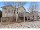 View of backyard from home's deck and stairs, with grass and tree at 1752 Peninsula Cir, Castle Rock, CO 80104