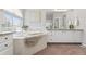 Elegant bathroom featuring large soaking tub, double sinks, and sleek cabinetry at 1752 Peninsula Cir, Castle Rock, CO 80104