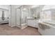 Bright bathroom features a glass enclosed shower, modern fixtures, and separate soaking tub at 1752 Peninsula Cir, Castle Rock, CO 80104