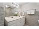 Bathroom with double sink vanity, large mirror and decorative tile backsplash at 1752 Peninsula Cir, Castle Rock, CO 80104