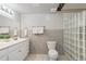 Bathroom featuring double vanity, tile backsplash, toilet and a glass block shower wall at 1752 Peninsula Cir, Castle Rock, CO 80104