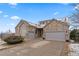Attractive exterior features stone accents, a three-car garage, and solar panels creating an inviting curb appeal at 1752 Peninsula Cir, Castle Rock, CO 80104