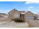 Stone home with a three-car garage, solar panels, and a well-maintained front lawn at 1752 Peninsula Cir, Castle Rock, CO 80104