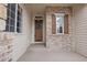 Welcoming front porch with a decorative wreath, sidelight windows, and brick accents creating an inviting entry at 1752 Peninsula Cir, Castle Rock, CO 80104