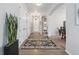 Inviting hallway featuring hardwood floors, decorative rug, and a view leading to other rooms at 1752 Peninsula Cir, Castle Rock, CO 80104