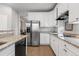 Stylish kitchen with white cabinets, granite countertops, and stainless steel refrigerator at 1752 Peninsula Cir, Castle Rock, CO 80104