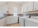 Convenient laundry room equipped with washer, dryer, sink, and ample cabinet storage at 1752 Peninsula Cir, Castle Rock, CO 80104