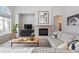Cozy living room featuring a fireplace, a comfortable sofa, and stylish decor at 1752 Peninsula Cir, Castle Rock, CO 80104