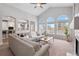 Spacious living room with large windows, vaulted ceiling, and open access to the kitchen at 1752 Peninsula Cir, Castle Rock, CO 80104