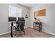 Well-appointed home office with dual monitors, comfortable chair, and stylish rolling cart at 1752 Peninsula Cir, Castle Rock, CO 80104
