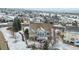 Aerial view of the home's back exterior, including a deck, fenced yard, mature trees, and a charming neighborhood setting at 1752 Peninsula Cir, Castle Rock, CO 80104