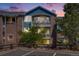 Attractive two-story building featuring brick and blue siding with balconies at sunset at 2672 S Cathay Way # 304, Aurora, CO 80013