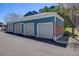 A row of detached garages featuring neutral doors and blue siding at 2672 S Cathay Way # 304, Aurora, CO 80013