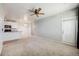 Open living room featuring neutral color palette, ceiling fan, and carpeted flooring at 2672 S Cathay Way # 304, Aurora, CO 80013