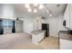 Open concept living area with kitchen island, stainless steel appliances and view of the window at 2672 S Cathay Way # 304, Aurora, CO 80013