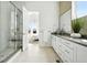 Bright bathroom with glass shower, double vanity, and neutral tile flooring at 4855 Saddle Iron Rd, Castle Rock, CO 80104